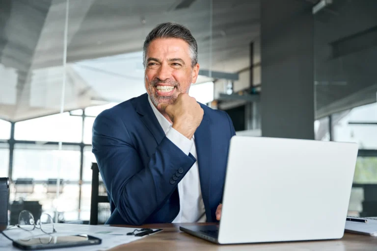 man smiling while on laptop