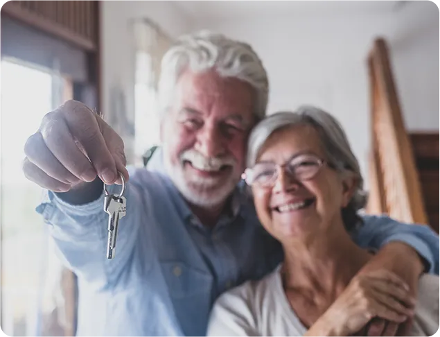 older couple holding a key